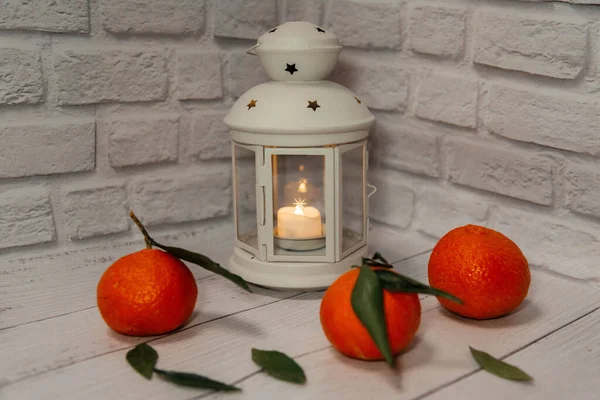 New Years white lantern on a white background decorated with tangerines.