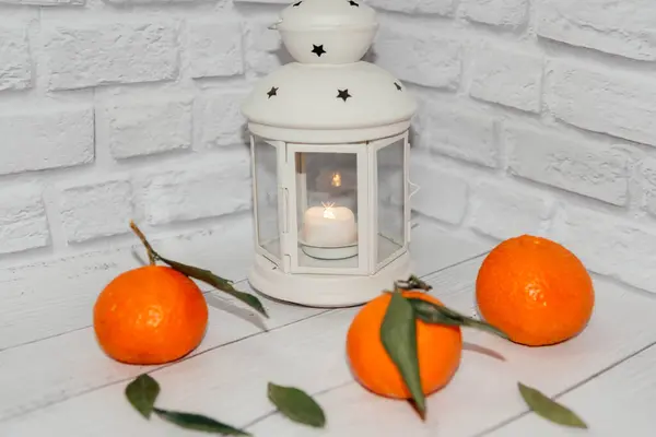 New Years white lantern on a white background decorated with tangerines.