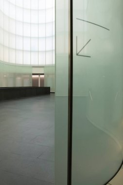 Black stair with LED lights on in a modern room surronded by glass wall. Nobody inside