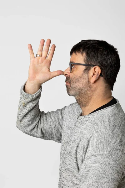 Man Profile Wearing Gray Sweater Brings Right Hand Nose Grimaces — Stock Photo, Image