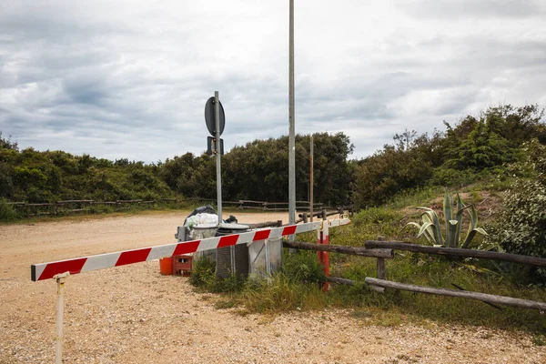 stock image Rubbish bins at the edge of a dirt road in a seaside landscape. Nobody inside