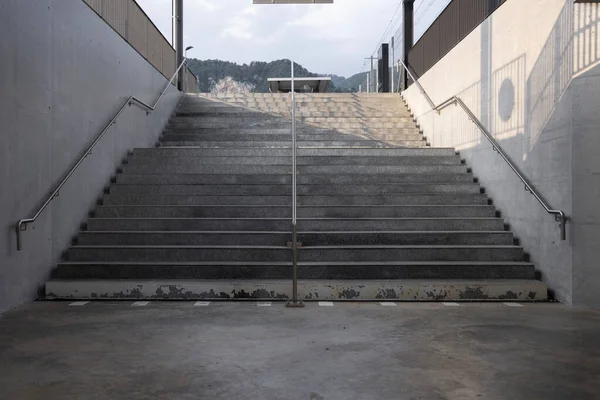 Front view of a stairway seen from below in a concrete station. Nobody inside