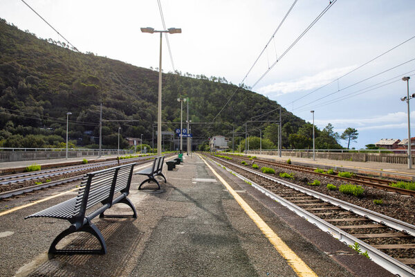 Devia Marina station tracks in Italy. No trains, no people, complete desolation and sadness. An empty bench.