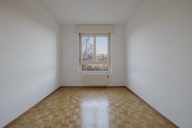 Parke zeminli, ağaçlara ve dağlara bakan parlak pencereli bir yatak odasının önü. Kış sahnesi