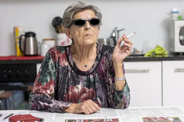 Portrait Old Smoker Sitting Her Modern White Kitchen Dark Sunglasses Royalty Free Stock Photos
