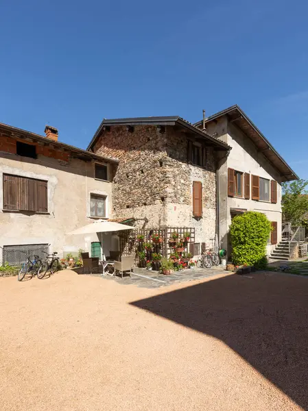 Bağlı tatil evleri, İtalyan tarzı, büyük bir bahçesi ve park edilmiş bisikletleri var. Güçlü gölgelerle güneşli bir yaz günü.