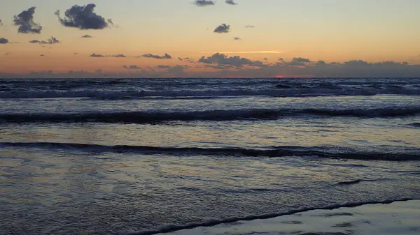 Güneş doğarken okyanus dalgalarının karanlık gündoğumu manzarası