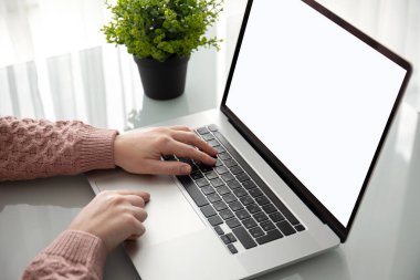 female hands on laptop keyboard with isolated screen at a table in the offic