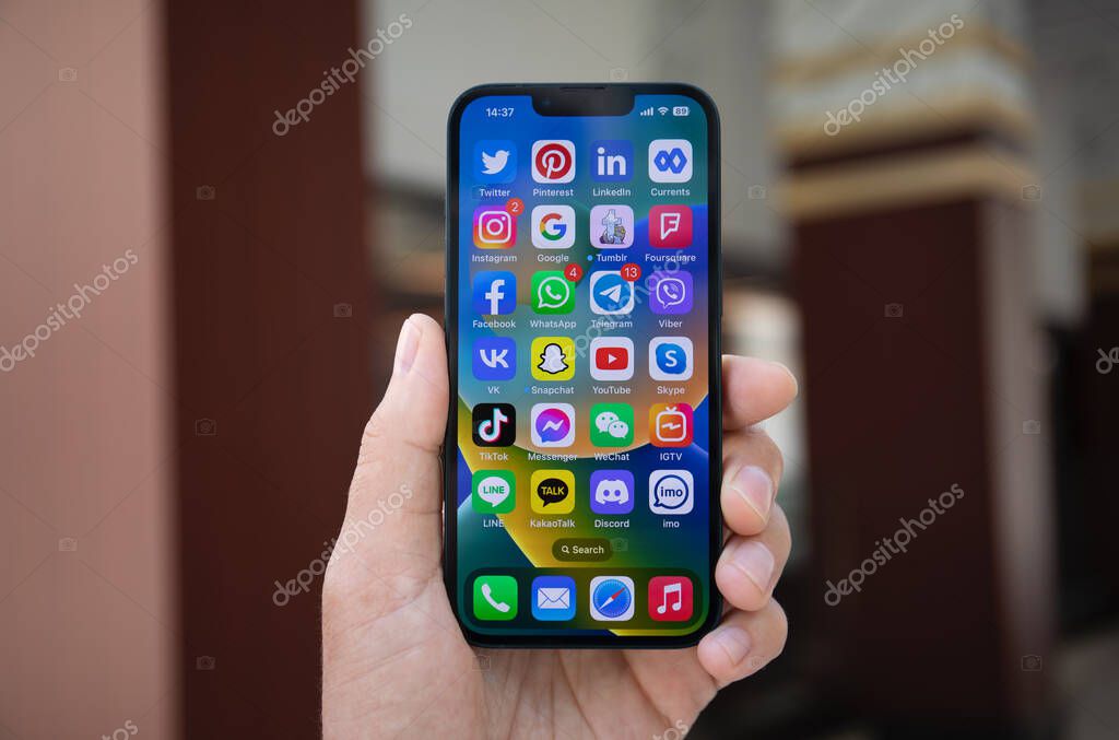 Alanya, Turkey - May 2, 2023: Man holding Apple iPhone 14 with social networking Messenger on the screen. iPhone 14 was created and developed by the Apple inc.