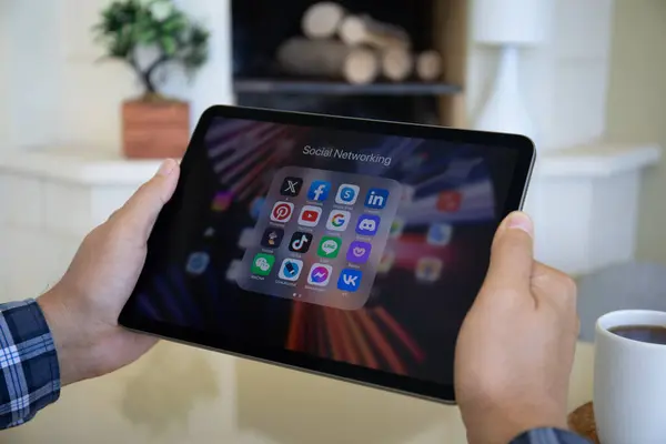 stock image Alanya, Turkey - September 19, 2023: Set programs of social networking messenger on the screen iPad Air in man hands. iPad Air was created and developed by the Apple inc