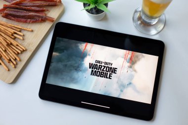 Alanya, Turkey - May 3, 2024: Tablet Apple iPad with game Call of Duty Mobile in the screen. Games Call of Duty was created by the Activision Publishing, inc. clipart