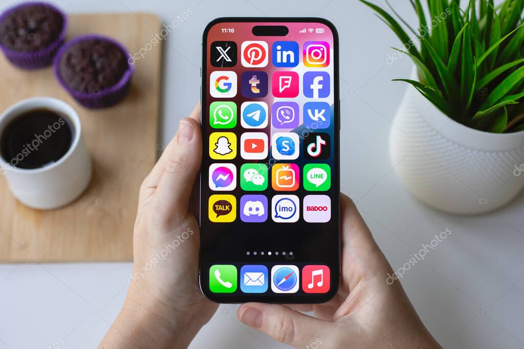 Alanya, Trkiye - June 13, 2024: Woman hand hold Apple iPhone 15 Pro Max with social networking Messenger  on the screen IOS 18.