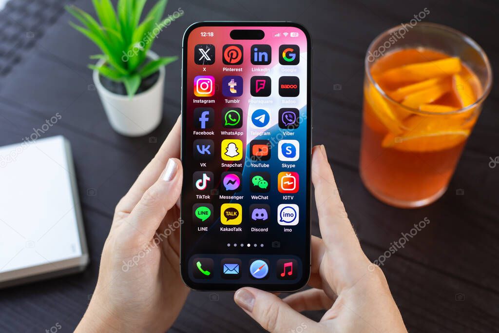 Alanya, Turkiye - July 31, 2024: Man hand hold Apple iPhone 15 Pro Max with social networking Messenger on the screen IOS 18.