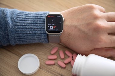 Alanya, Turkey - February 17, 2019: Man hand with Apple Watch Series 4 with the Heart Rate app on the screen. Apple Watch was created and developed by the Apple inc.  clipart