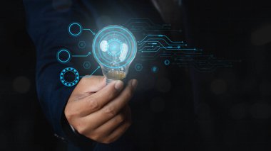 Businessman holding glowing light bulb with digital transformation change management, internet of things. Future technology Virtual Holographic interface. innovation concept.