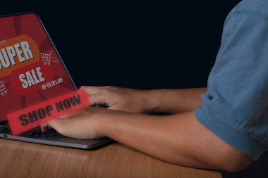 Young man using computer shopping online with SUPER SALE discount banner promotion, E-commerce business online. Shopping online concept.