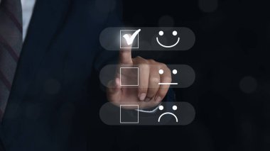 Businessman Hand choosing screen on happy Smiley face icon to give satisfaction in service. rating very impressed. Customer service and Satisfaction concept.