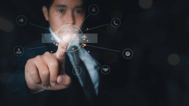 Contact us or Customer support hotline people connect. Businessman touching virtual screen contact icons. Customer service call center contact us concept.