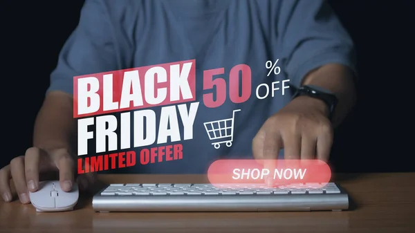 Young man using computer shopping online with black friday discount banner promotion, E-commerce business online. Shopping online concept.