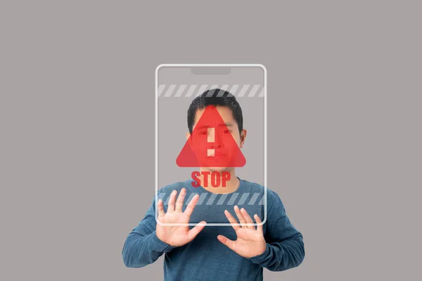 Young man showing stop gesture with stop sign virtual screen. Warning and alert attention signs. Caution futuristic design elements in modern technology style.