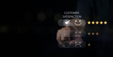 Customer satisfaction experience concept. Businessman choosing  happy smiley face icon to give satisfaction in service. rating very impressed. copy space.