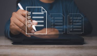 Electronic signature and paperless office concept. Businessman uses a pen sign electronic documents on a virtual screen. Business and technology document management concept.