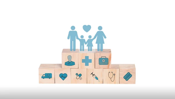 Family with insurance for your health concept. Wooden blocks with healthcare medical icons and family icons on white background, copy space.