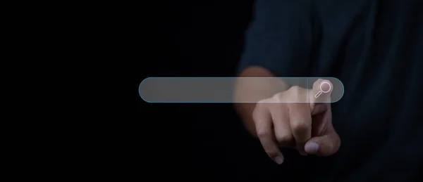 Stock image Searching browsing internet data information networking concept. Search Engine Optimization SEO Networking. Man hand presses the information search button on search bar virtual screen, copy space.