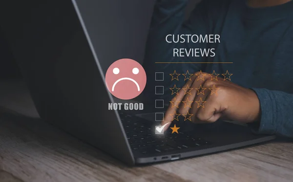 Customer satisfaction experience concept. Unhappy man Client with sadness emotion face on laptop, bad review, social media not good. User give rating to service experience online application.