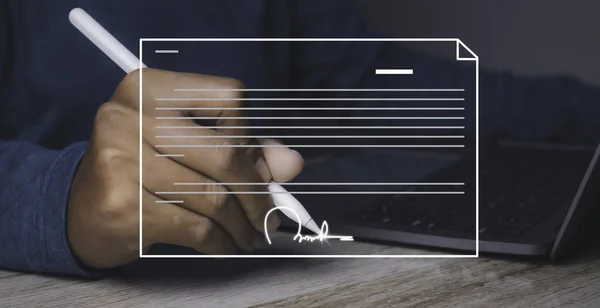 Electronic signature and paperless office concept. Businessman uses a pen sign electronic documents on a virtual screen. Business and technology document management concept.