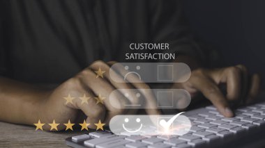 Customer satisfaction experience concept. Businessman choosing  happy smiley face icon to give satisfaction in service. rating very impressed. copy space.