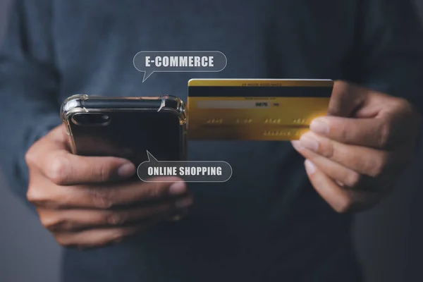 Shopping online by credit card with mobile smart phone. Businessman using mobile phone and credit card shopping online with icons E-commerce business online. copy space.