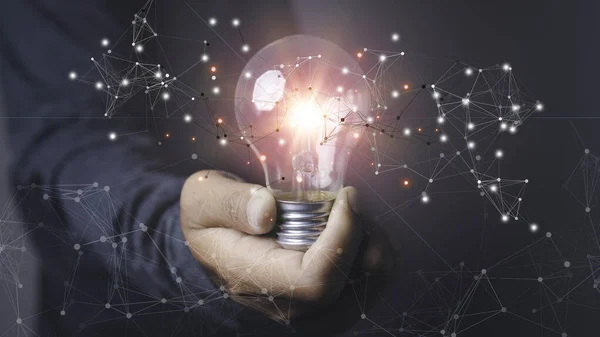 New ideas and innovation technology and creative. Man holding light bulbs creative thinking new ideas. Business, Development, Concept creativity with digital network connection.