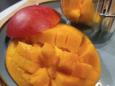 Fresh and ripe mango fruit on a plate