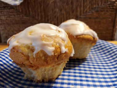 Two fresh muffins on a blue and white plate