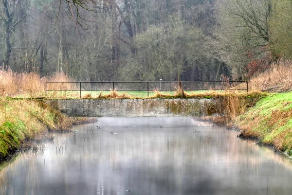 stock image Water trench and bridge in the Rieselfelder irrigation fields in Munster
