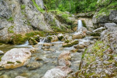 Kuhflucht waterfall and Kuhfluchtgraben creek in Farchant in Bavaria clipart