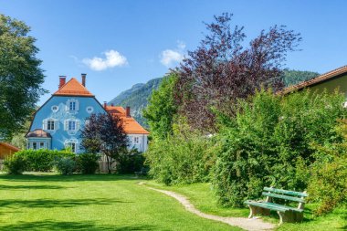 Historical blue house and park in Mittenwald in Bavaria clipart