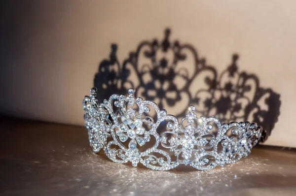 stock image Royal diamond diadem with shadows lying on table. Fairy tale