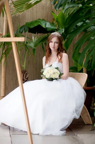 Bride in white wedding dress with flower bouquet
