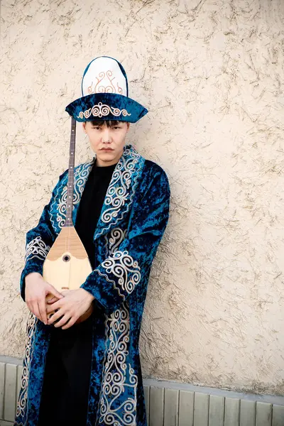 stock image Kazakh man in national ethnic costume with chapan and dombra