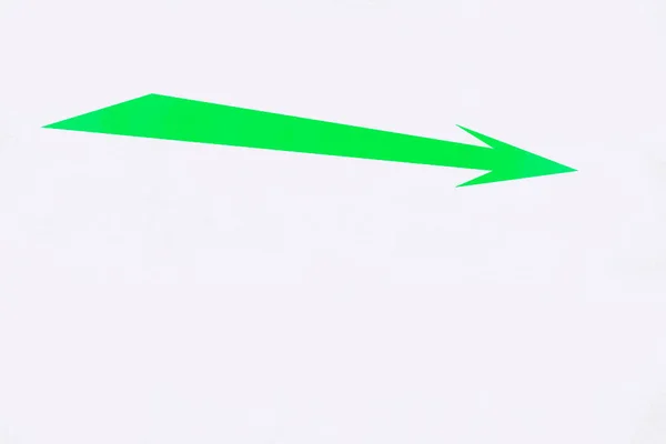 Green arrow on a white background. The concept of the direction of movement.