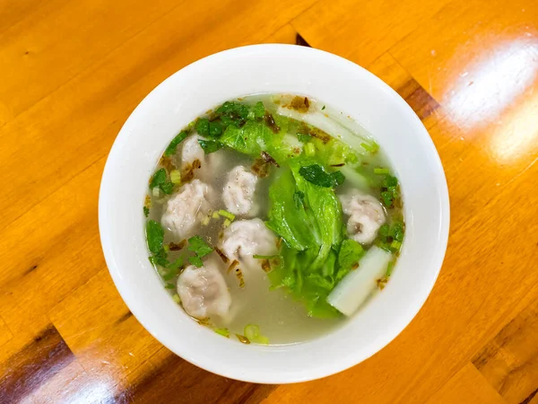 stock image Wonton soup bowl. Shrimp or pork wonton soup with green onion, top view, copy space