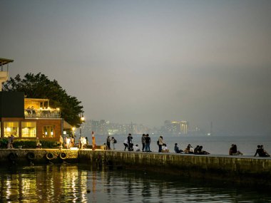 New Taipei City, Taiwan - JANUARY 14, 2023: Beautiful mist landscape of Tamsui on JANUARY 14,2023 in New Taipei City, Taiwan.It's popular sunset spot with visitors from Taipei.