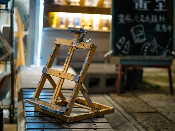 wooden drawing stand on the city street for drawing in night.