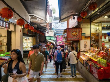 YENİ TAIPEI TAIWAN - 27 Ağustos 2024: Gezen ve alışveriş yapan turistlerle Jiufen eski caddesi. Geleneksel Çin fenerleri dar sokaklar boyunca asılı. Taipei yakınlarında popüler bir seyahat merkezidir..