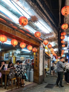 NEW TAIPEI TAIWAN - August 27 ,2024 :Jiufen old street with tourists walking and shopping. Traditional chinese lanterns hanging along the narrow street.It is a popular travel destination near Taipei. clipart