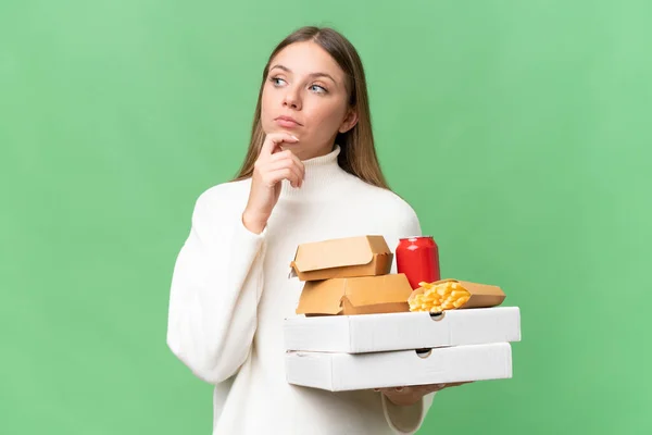 Young Beautiful Blonde Woman Holding Takeaway Food Isolated Background Looking — Stock Photo, Image