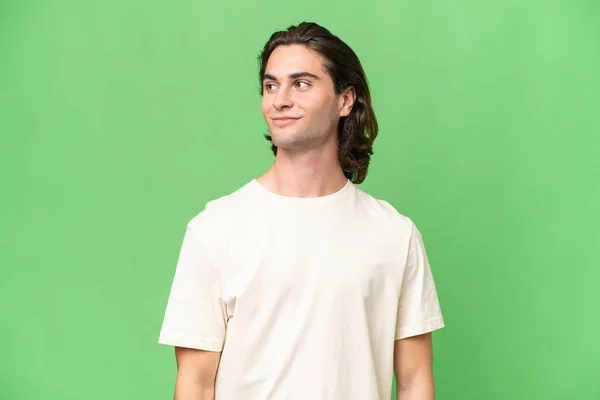 Young Caucasian Man Isolated Green Chroma Background Having Doubts While — Stock Photo, Image