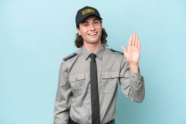 Young Safeguard Man Isolated Blue Background Saluting Hand Happy Expression — Stock Photo, Image